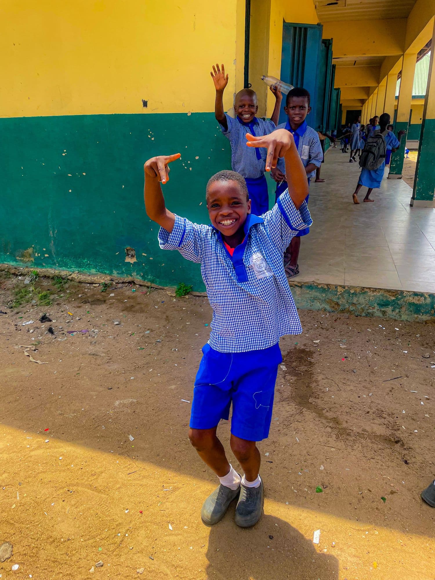 A pupil jumping for joy in a school corridor