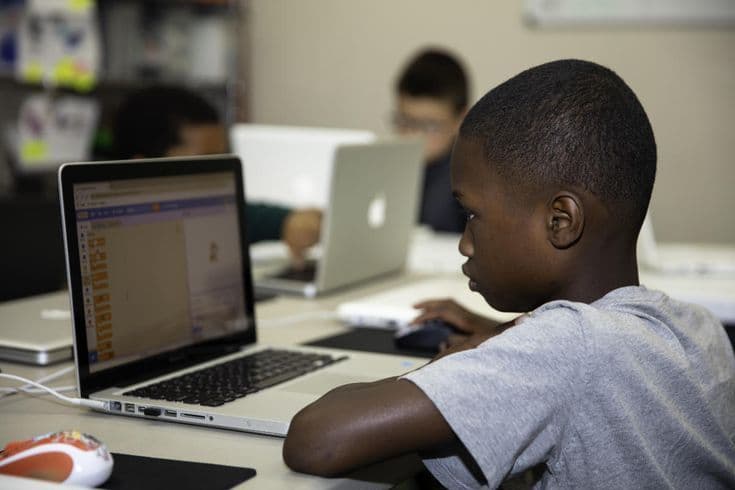 A boy working on a laptop