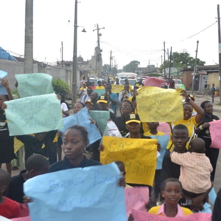Young people holding handwritten placards at a march