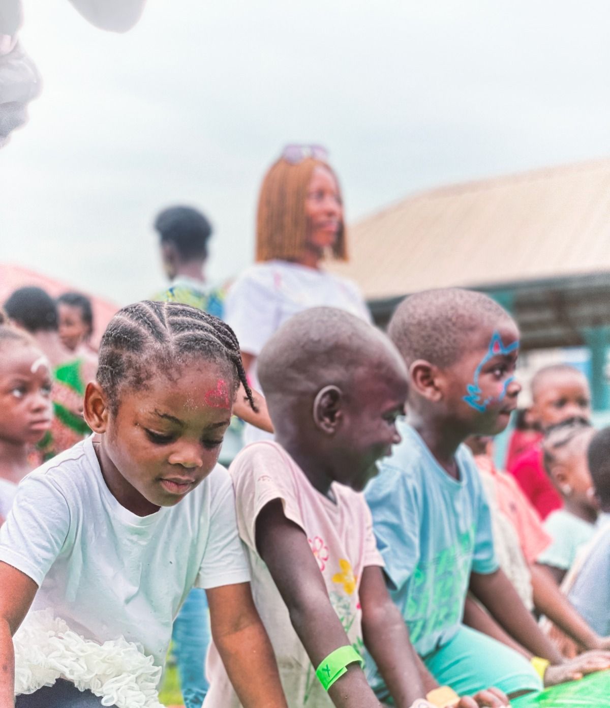 Children writing at a table during the essay competition