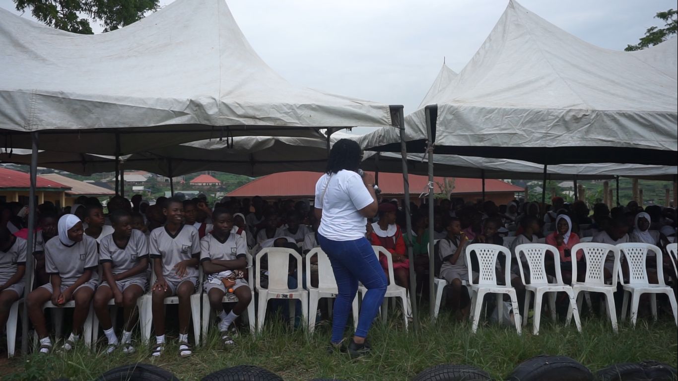 Hundreds of girls seated under canopies during the Girls Emerging session
