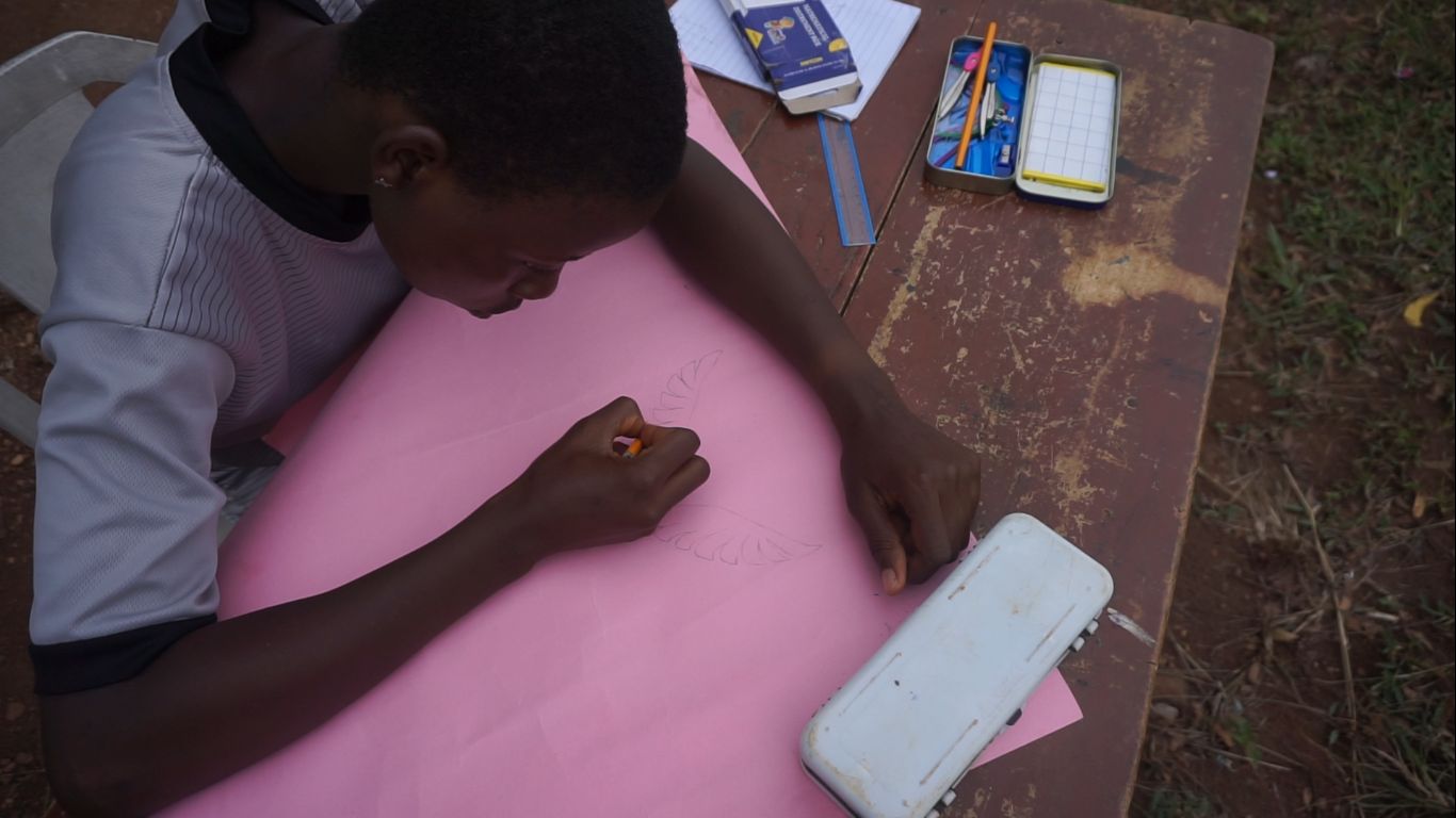 A girl sketching a drawing during the Girls Emerging event